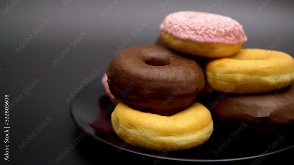 Selection of delicous Donuts on a plate - close up Selection of delicous Donuts on a plate - close up