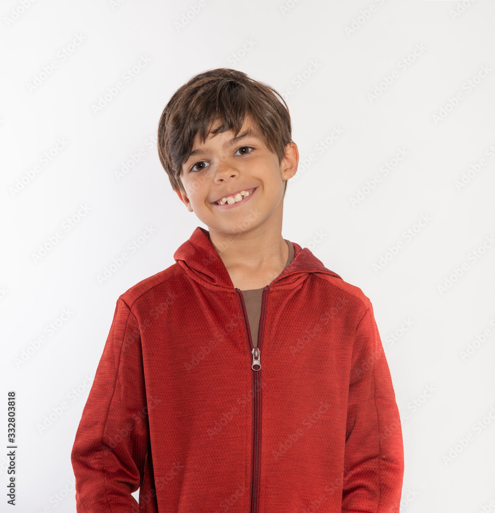 Smiling boy with teeth coming in wearing red hoodie jacket isolated on white background Smiling boy with teeth coming in wearing red hoodie jacket isolated on white background