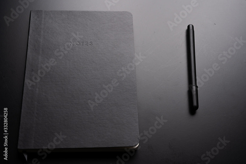 Black style set: notepad and pen on Black background