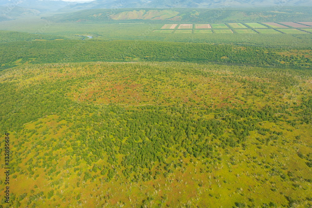 aerial view of Kamchatka volcanos, green valleys, snow and ice and the wonderful view of pure nature. aerial view of Kamchatka volcanos, green valleys, snow and ice and the wonderful view of pure nature.