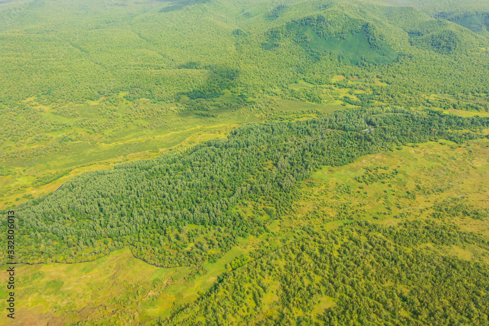 aerial view of Kamchatka volcanos, green valleys, snow and ice and the wonderful view of pure nature.