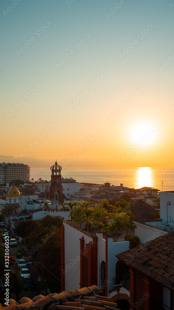 Amazing Orange Sunset Over Blue Ocean on a Rooftop view of Old Town in Puerto Vallarta Mexico