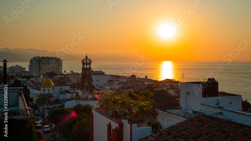 Amazing Orange Sunset Over Blue Ocean on a Rooftop view of Old Town in Puerto Vallarta Mexico