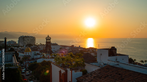 Amazing Orange Sunset Over Blue Ocean on a Rooftop view of Old Town in Puerto Vallarta Mexico