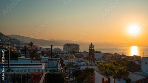 Amazing Orange Sunset Over Blue Ocean on a Rooftop view of Old Town in Puerto Vallarta Mexico