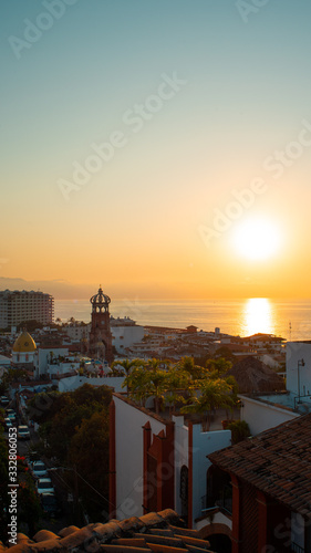 Amazing Orange Sunset Over Blue Ocean on a Rooftop view of Old Town in Puerto Vallarta Mexico