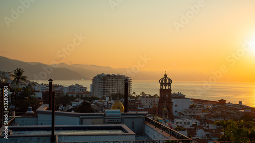 Amazing Orange Sunset Over Blue Ocean on a Rooftop view of Old Town in Puerto Vallarta Mexico