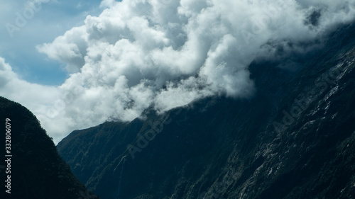 Rolling clouds over mountains at Milford Sound New Zealand