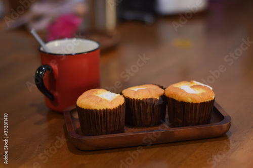 Morning coffee with coconut chiffon cake on wooden table.