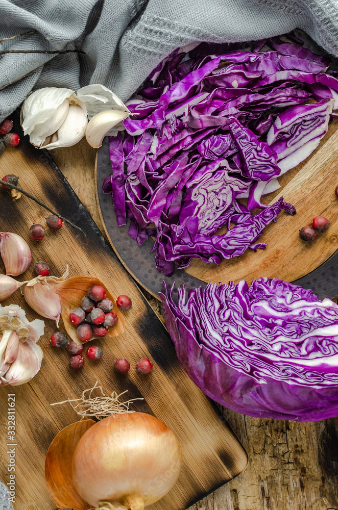 Cabbage, Onions, Garlic and dry fruits ready for vegetable salad over rustic old wood table