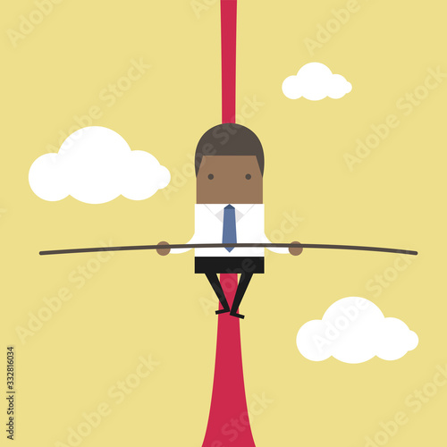 African businessman balancing on rope.