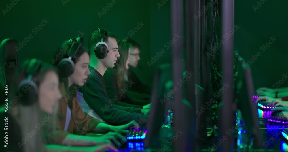 Winning an online computer game. Players are happy, they are winners. Players scream with joy and punch. Team game in a modern computer club. Winning an online computer game. Players are happy, they are winners. Players scream with joy and punch. Team game in a modern computer club.