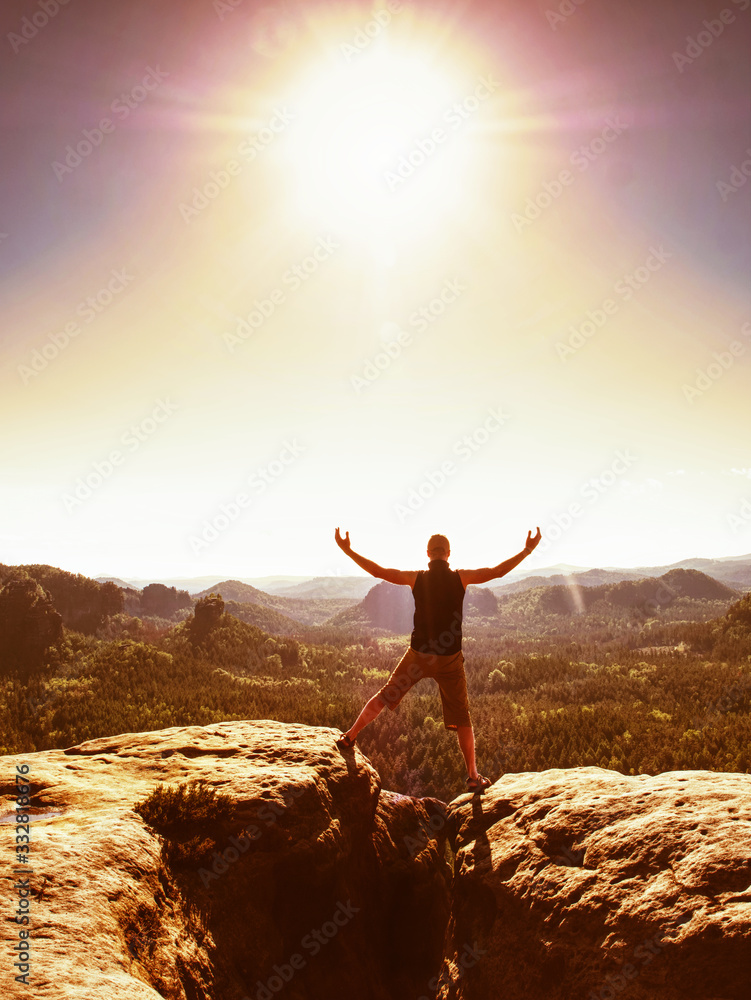 Man celebrating or praying in amazing mountains sunrise
