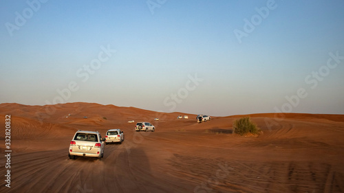 A group of SUV's go dune bashing in the deserts of Dubai, UAE © Jeffrey