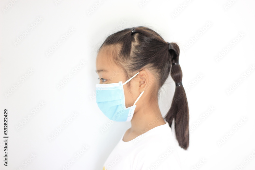 Children girl is protective surgical mask on their face and prevent Air pollution pm2.5 concept and Coronavirus Covid-19. Children girl is protective surgical mask on their face and prevent Air pollution pm2.5 concept and Coronavirus Covid-19.