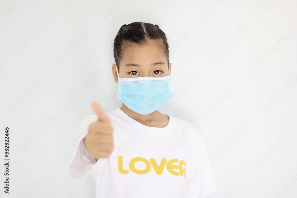 Children girl is protective surgical mask on their face and prevent Air pollution pm2.5 concept and Coronavirus Covid-19. Children girl is protective surgical mask on their face and prevent Air pollution pm2.5 concept and Coronavirus Covid-19.
