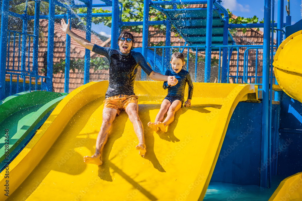 Obraz premium Father and son on a water slide in the water park