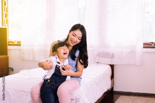 Asian single mom ticklish and carrying to cheerful daughter in bedroom