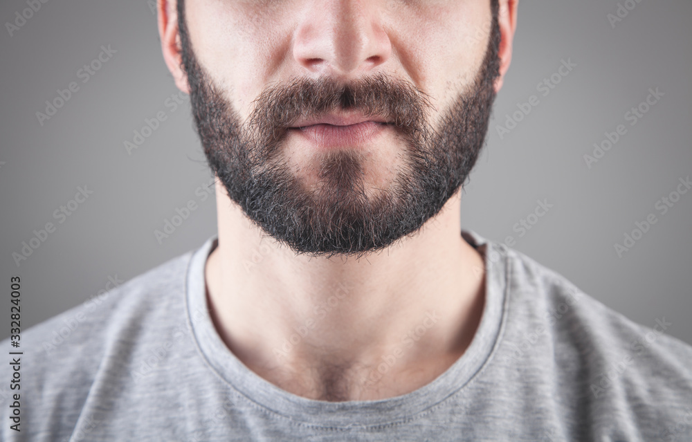 Caucasian bearded man in grey background. Caucasian bearded man in grey background.