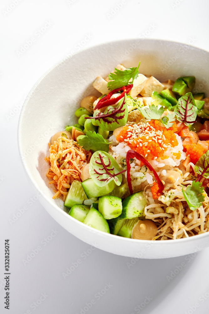 Poke with salmon, cut avocado and tofu closeup view Poke with salmon, cut avocado and tofu closeup view