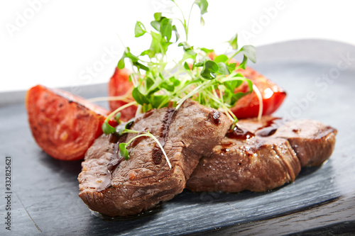 Grilled marbled beef with tomatoes top view