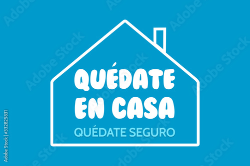 illustration with the phrase in Spanish quedate en casa quedate seguro in recommendation for quarantine due to covid 19 or coronavirus photo