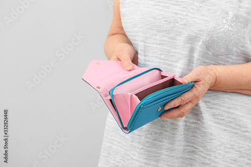 Senior woman with empty wal...