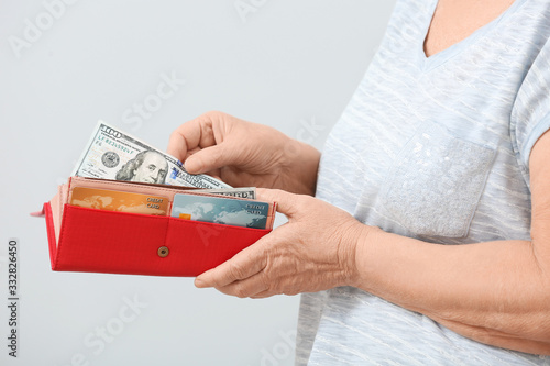 Senior woman with wallet an...