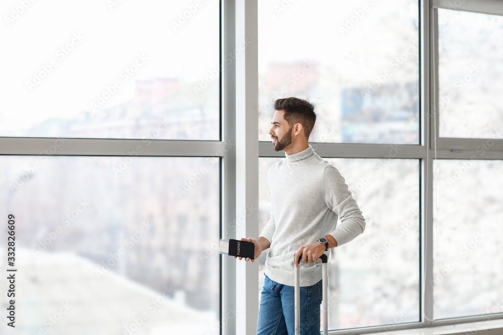 Young man waiting for his flight at the airport