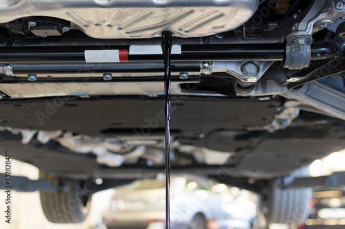 The old oil is drained from the car engine. Car maintenance. The car engine is bottom view. Oil change in the engine. Car service