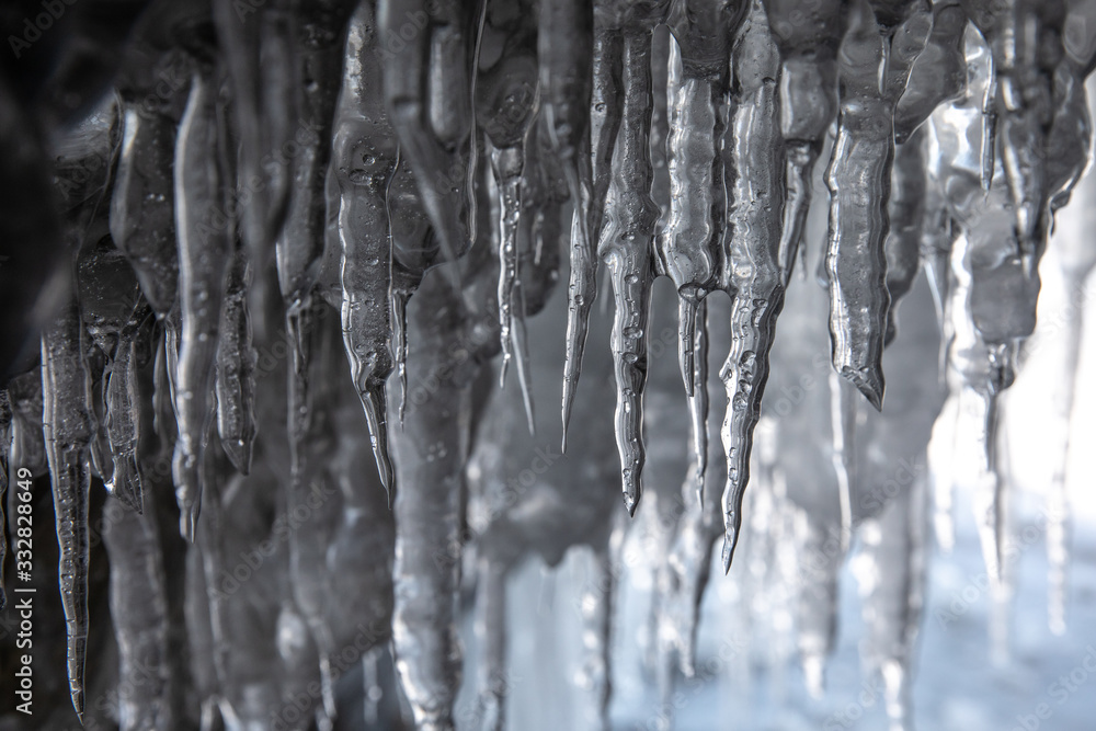Ice details of the frozen lake Baikal during a winter sunrise. Irkutsk, Siberia, Russia.