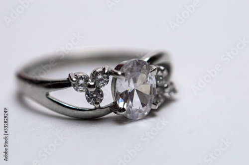 Silver ring with stones on blurred background