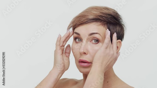 Wallpaper Mural Close-up of middle aged mature woman over white bacjground. Portrait of mature lady. Plastic surgery, beauty injections and cosmetology. Torontodigital.ca