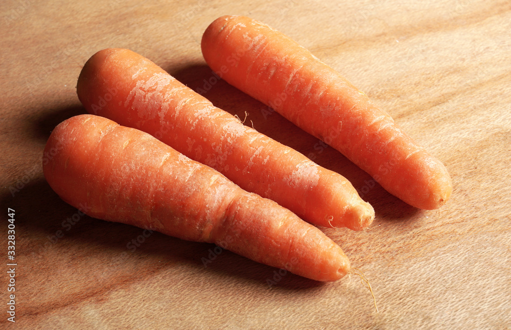 fresh carrot isolated on wooden background fresh carrot isolated on wooden background