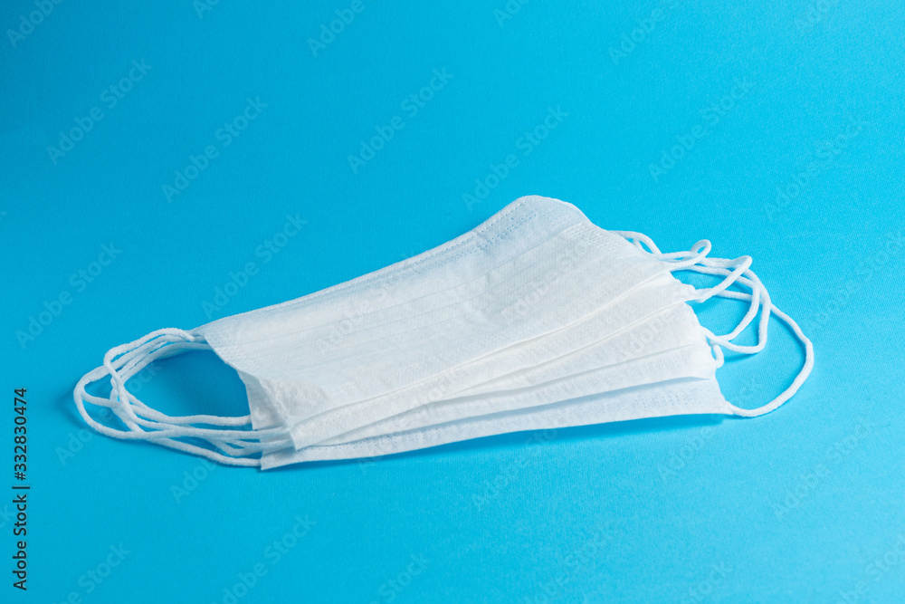 White medical masks on a blue background. side view White medical masks on a blue background. side view