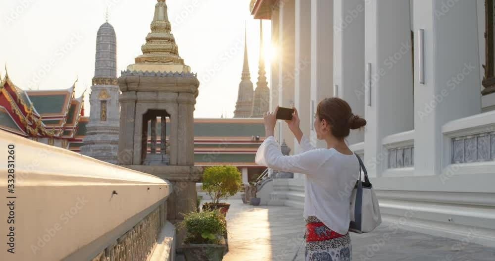 Woman go travel and take photo on cellphone at bangkok