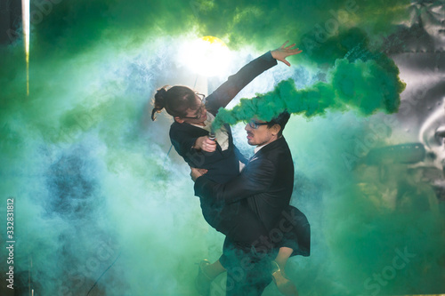 Pasadoble, latin solo dance and contemporary dance - Handsome man and woman dancing into smoke cloud.