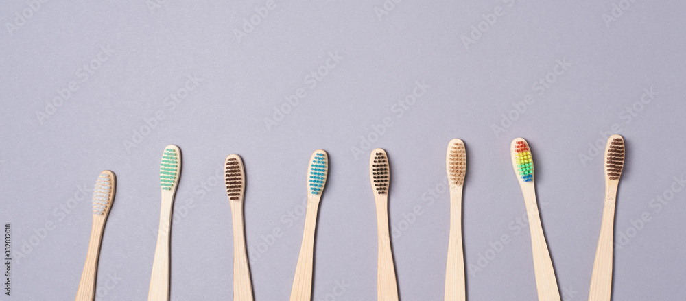 Set of bamboo toothbrushes. Different color. Copy space. Ecology wood tooth brush group. Grey background. Natural oral hygiene. Dental zero waste protection. Copyspace Set of bamboo toothbrushes. Different color. Copy space. Ecology wood tooth brush group. Grey background. Natural oral hygiene. Dental zero waste protection. Copyspace