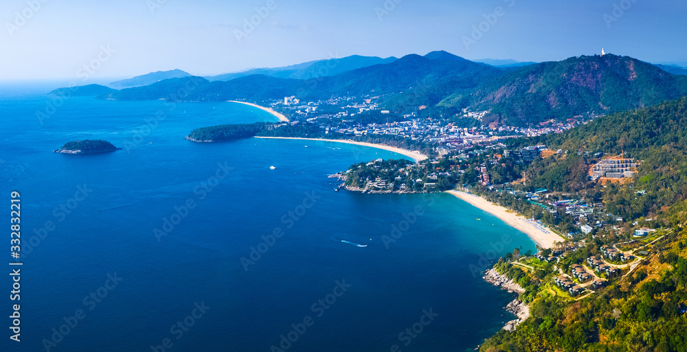 Aerial panorama of the green coastline with tropical beaches on the island of Phuket, Thailand