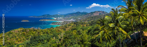 Panorama of the tropical island of Phuket with green trees on the foreground and perfect sandy beaches on the horizon, Thailand