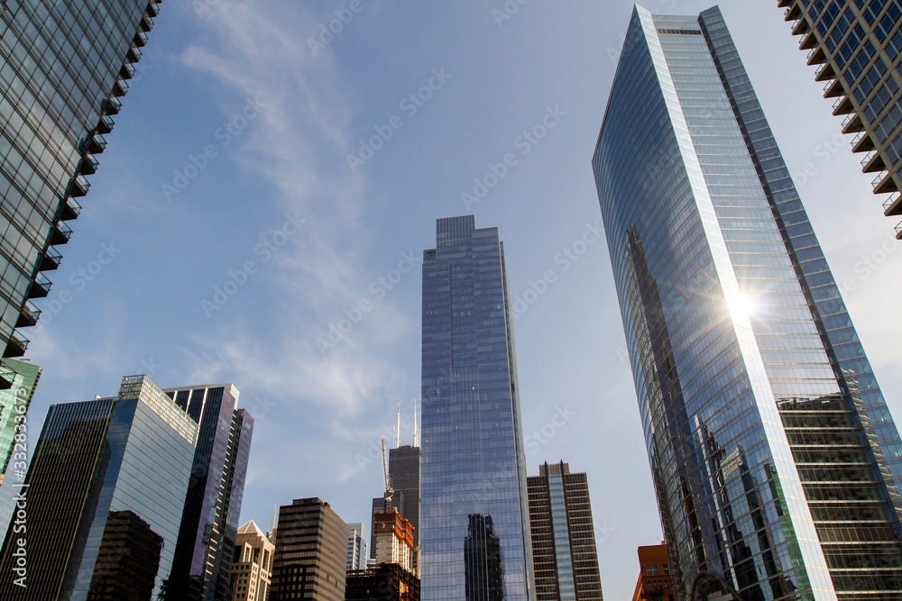 Modern skyscrapers in a financial district at sunset, looking up perspective, real estate and success concept, USA