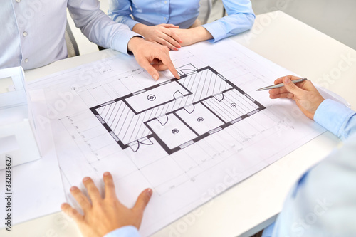 architecture, construction business and people concept - close up of architects discussing blueprint of house project at office