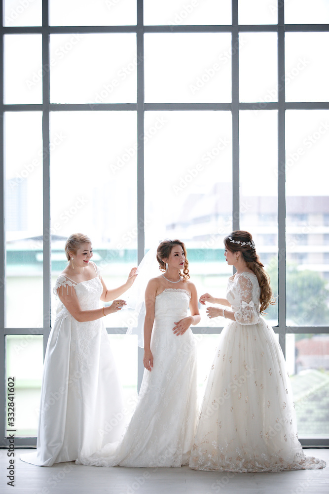 Fototapeta premium Group of beautiful brides arrange their dress..