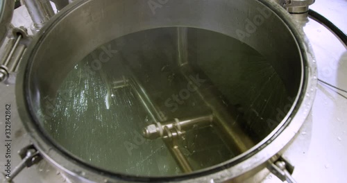 Medium shot sanitizing beer brewing tank with agitator rotating