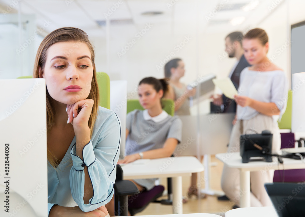 unhappy girl in modern open plan office