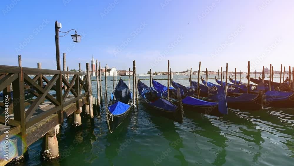 Moored gondolas on the background of sunrise. Venice, Italy. Moored gondolas on the background of sunrise. Venice, Italy.
