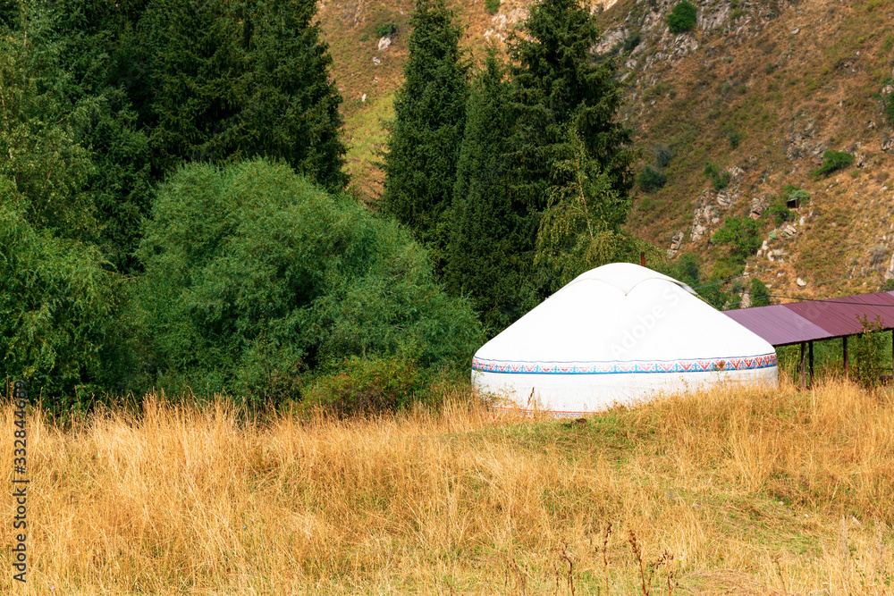 Yurt. The traditional home of the nomads. A yurt stands in the picturesque mountains. Travel to Asia