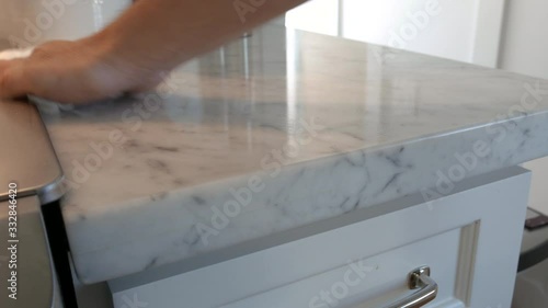 Disinfectant spray and wiping down a marble countertop. photo