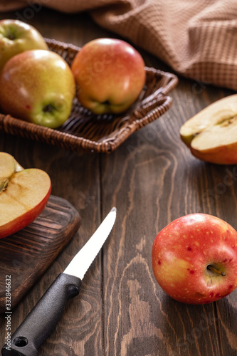 Fresh and juicy red apples in a basket on a wooden table