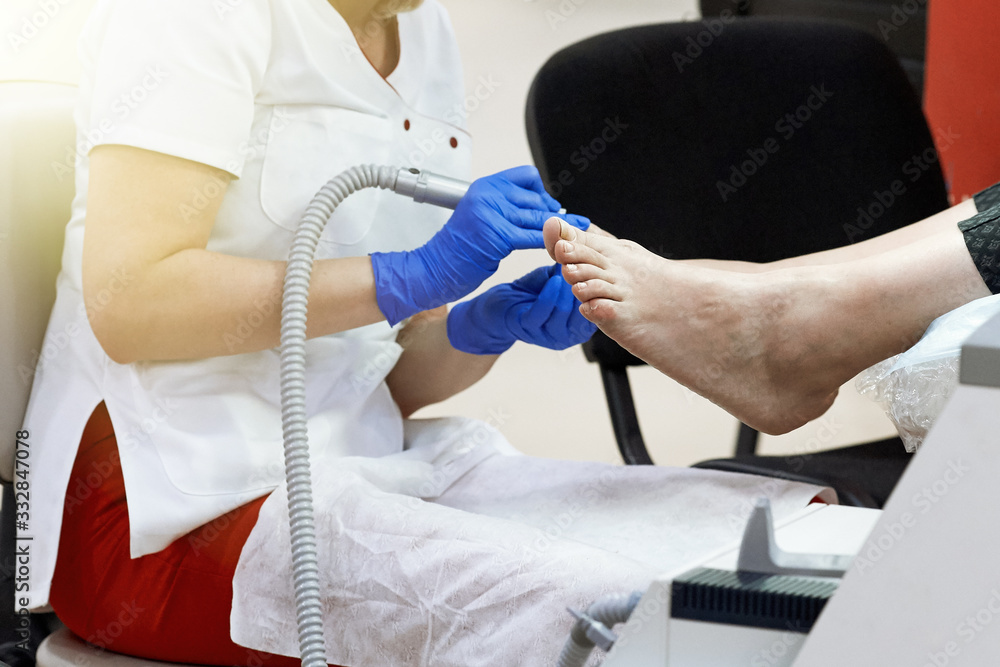 Closeup of a master pedicuring a client in a beauty salon